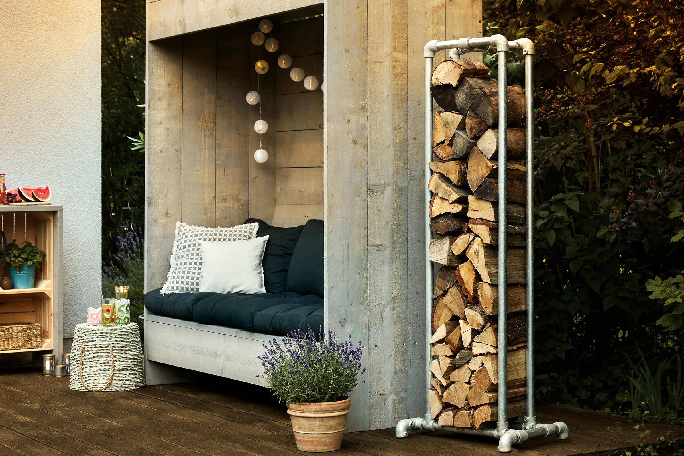 Spațiu exterior cu depozit de lemne, zonă de relaxare și decorațiuni pentru o atmosferă confortabilă