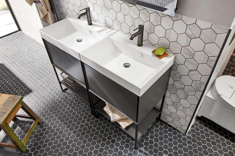 Baie cu două chiuvete, dulapuri inferioare întunecate și gresie hexagonală