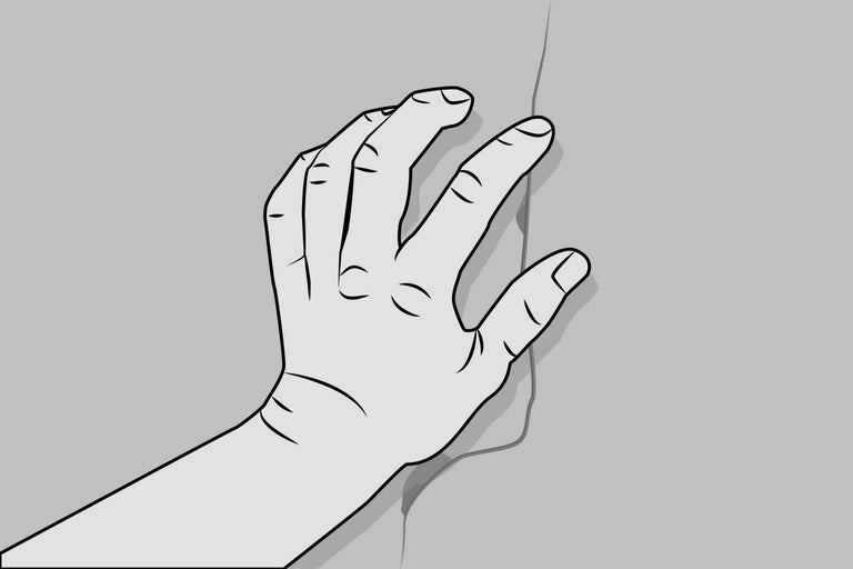 Mână pe o fisură în perete