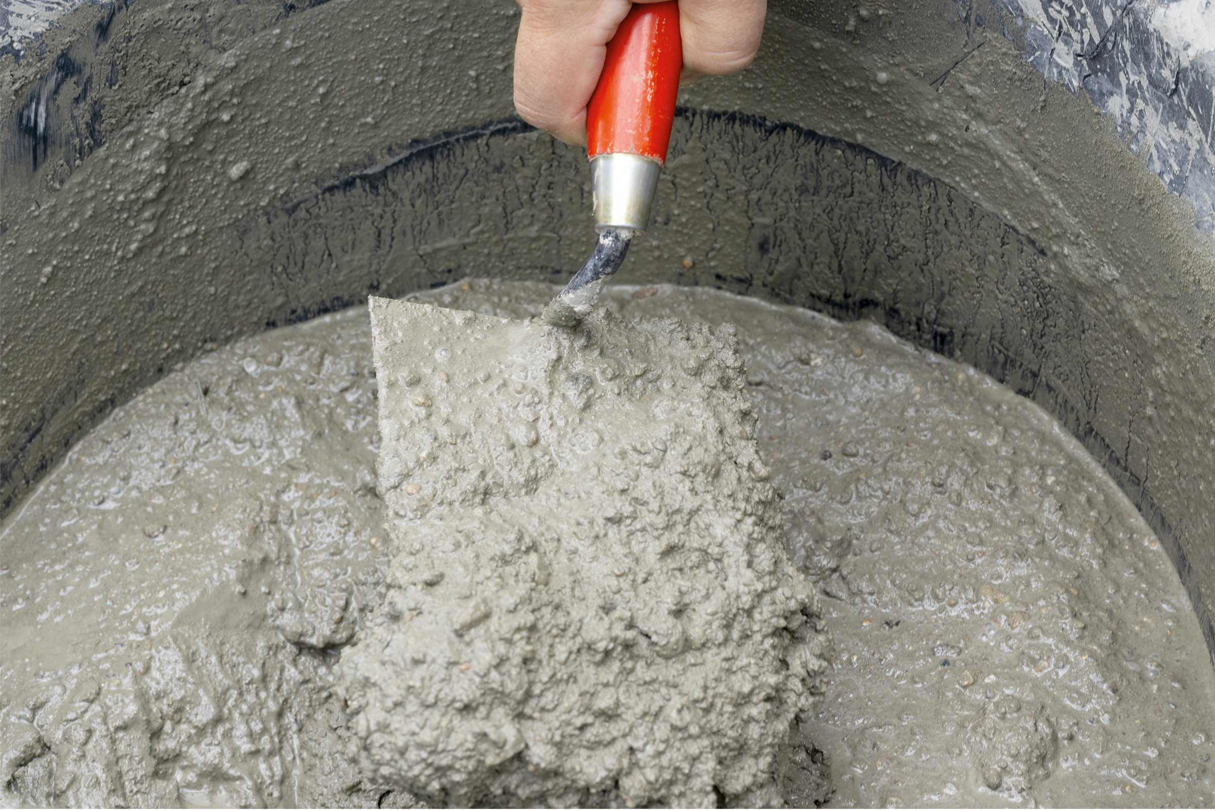 Mortar proaspăt amestecat în găleată cu mistrie de zidărie