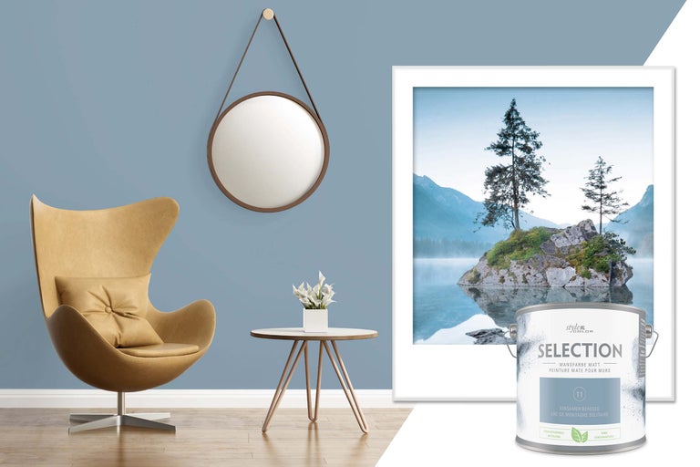 Scenă de locuit cu fotoliu, masă cu vază de flori, oglindă, imagine înrămată și cutie de vopsea de perete