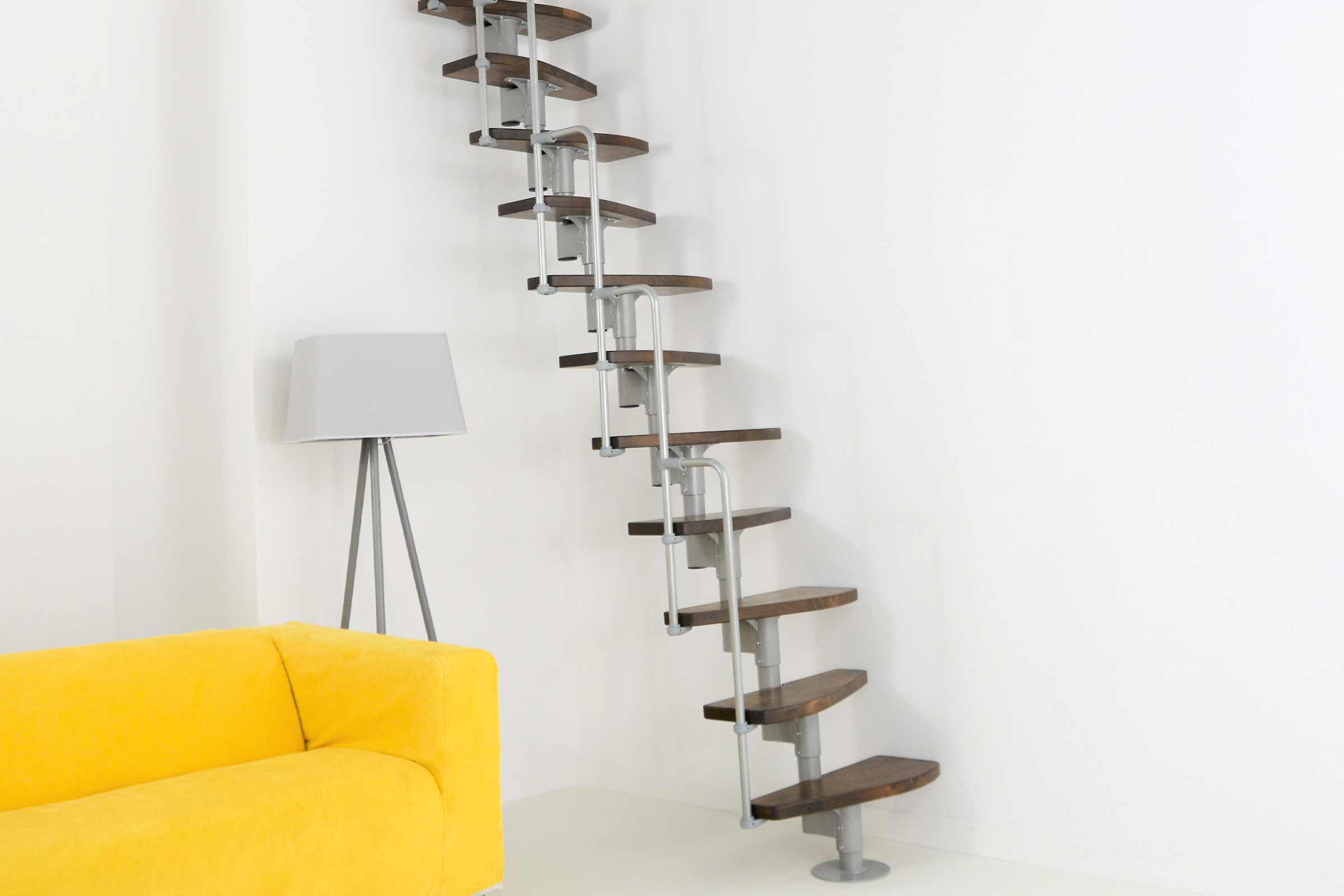 Vedere a camerei cu o scară din lemn cu balustradă metalică