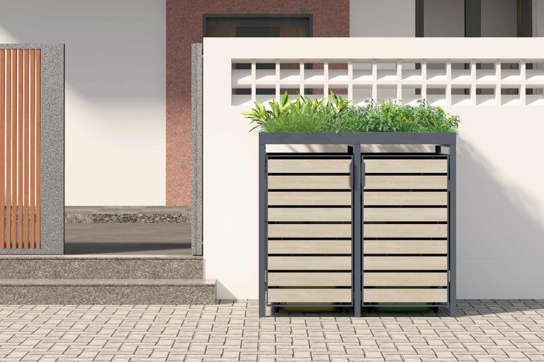 Adăpost dublu pentru pubele cu jardinieră în fața unei case