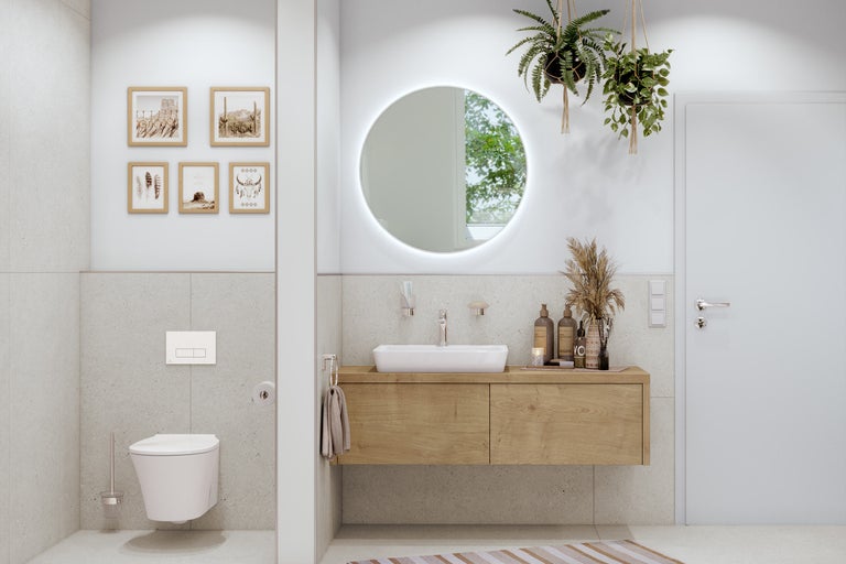 Baie luminoasă cu dulap de lavoar, toaletă și oglindă rotundă