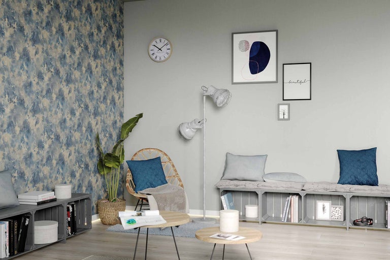 Cameră de zi cu fotoliu din ratan, lampadar, măsuță de cafea și picturi murale