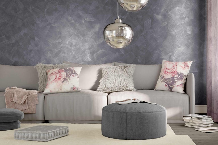 Cameră de zi luminoasă cu canapea, perne, taburet și decorațiuni