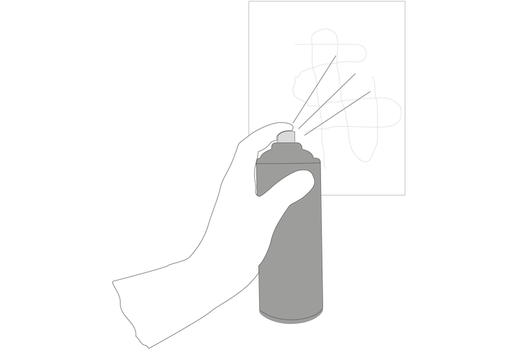 O mână ține un spray și pulverizează pe o suprafață.