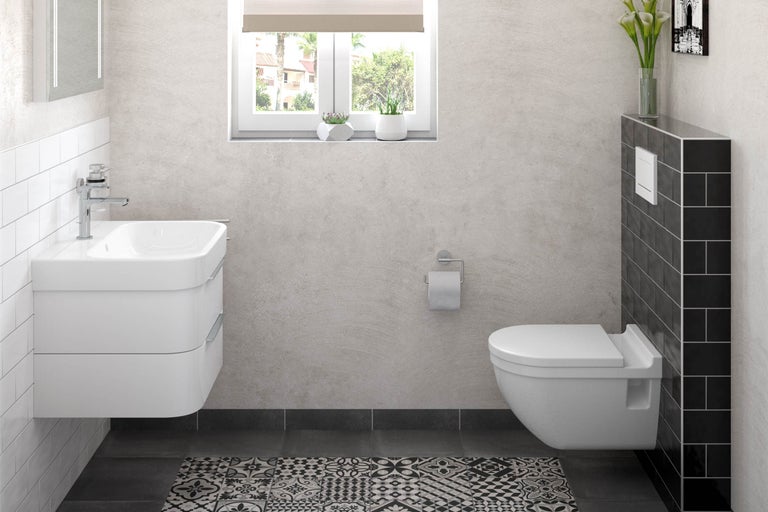 Baie luminoasă cu chiuvetă, toaletă și gresie cu model.