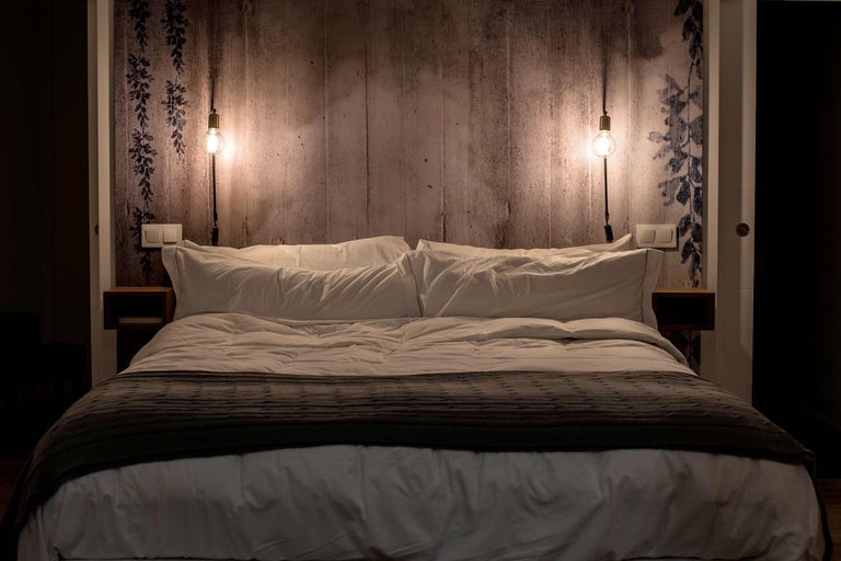 Dormitor cu pat dublu, noptiere și lămpi de perete