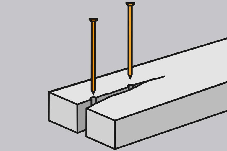 Două cuie într-o bucată de lemn
