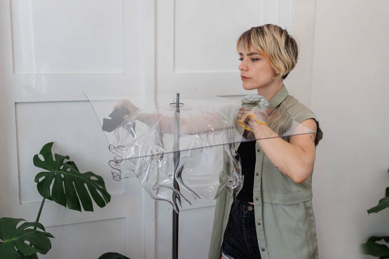 Femeie montează un abajur transparent pe o lampă