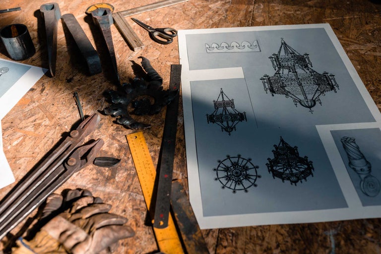Banc de lucru cu scule și schițe de design pentru candelabre