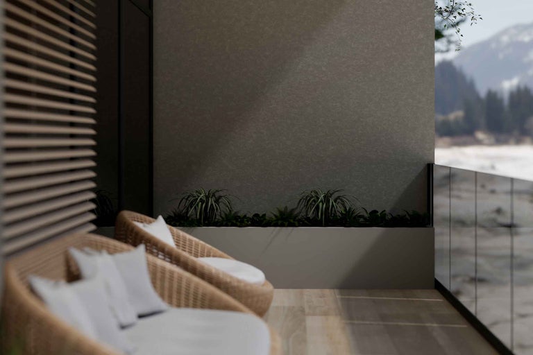 Balcon cu fotolii din ratan, plante și vedere la munte
