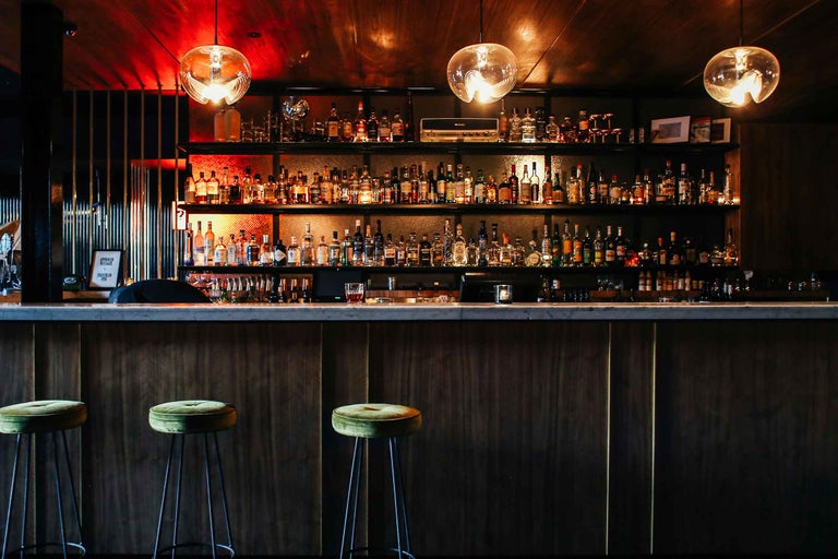 Bar cu raft pentru băuturi spirtoase, tejghea și scaune de bar