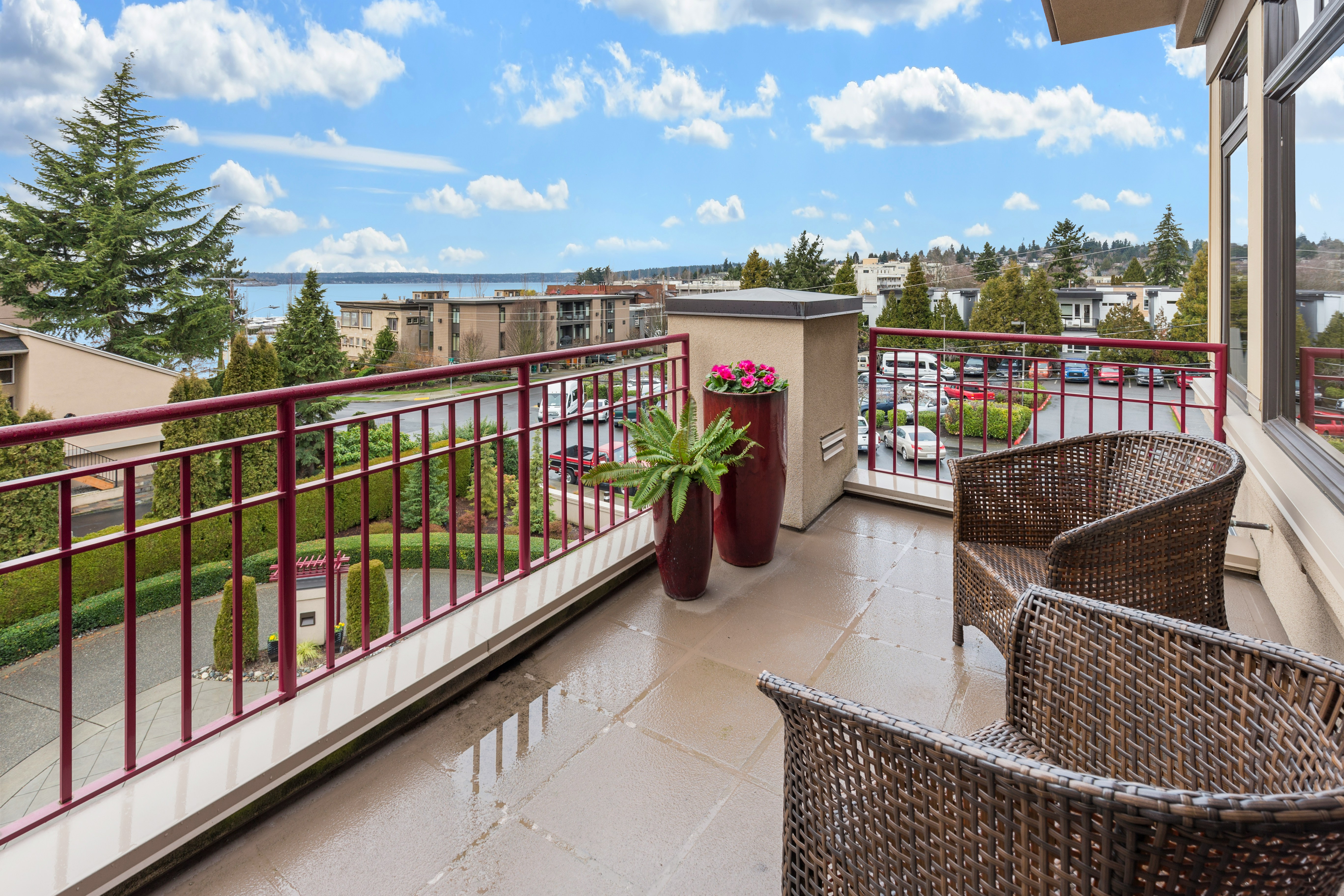 Balcon cu mobilier de grădină și vedere spre oraș.