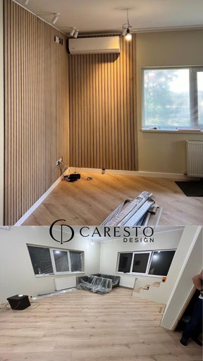 Living cu panouri acustice cu aspect de lemn pe perete, podea laminată și două ferestre, sigla Caresto Design.
