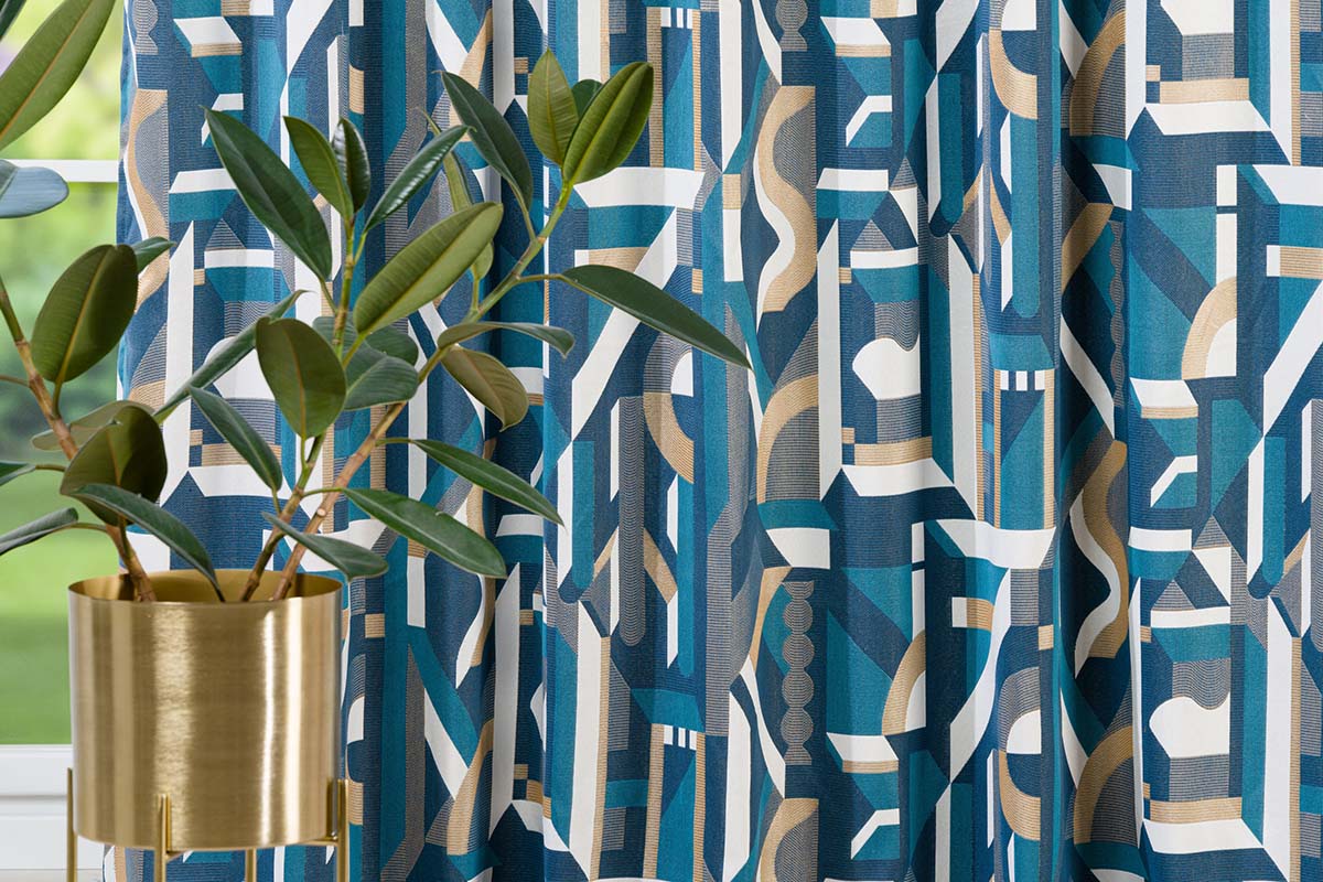 Cortină decorativă cu model geometric și plantă de interior în ghiveci