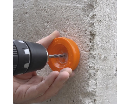 Găurire în beton cu un burghiu și cu o protecție pentru burghiu