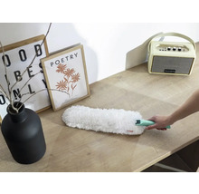 Pămătuf de praf cu mâner pe masă