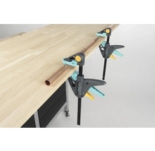 Banc de lucru cu două cleme de prindere cu o singură mână Wolfcraft și o țeavă de cupru.