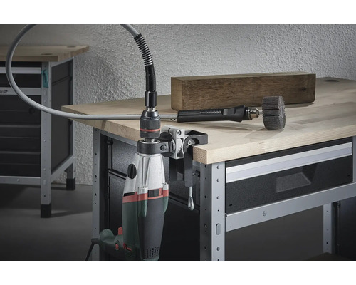 Mașină de găurit cu ax flexibil pe menghină pe un banc de lucru