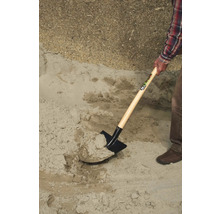 O persoană lopată nisip cu o lopată.