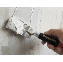 Artizan care aplică tencuială pe un perete cu mistria. Logo Maurerlob.