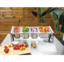 Stație de ingrediente din oțel inoxidabil cu patru recipiente Gastronorm umplute cu legume și sos pe o masă metalică cu tocător.