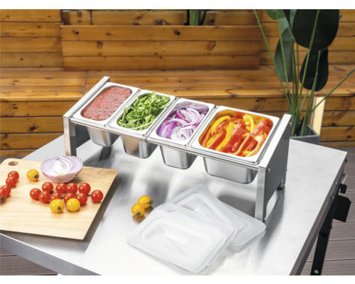 Stație de preparare Tenneker din oțel inoxidabil cu patru recipiente Gastronorm pe o masă metalică, umplută cu sosuri și legume tăiate pentru grătar.