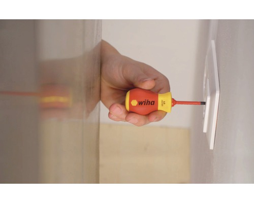 Un bărbat strânge o priză cu o șurubelniță Wiha.