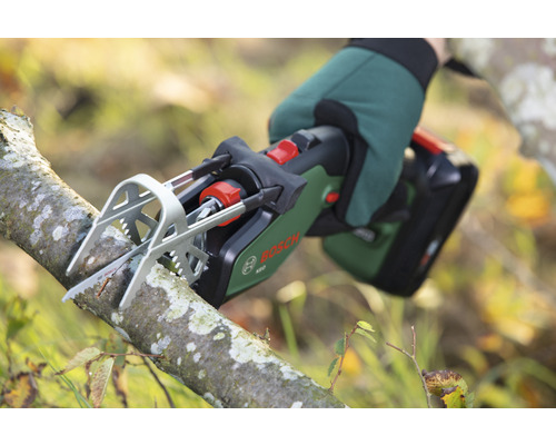 Fierăstrău de grădină cu acumulator care taie o ramură