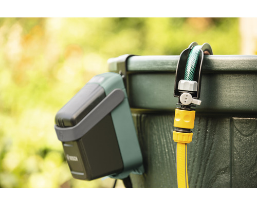 Sistem de irigare Bosch cu furtun de grădină pe un butoi de apă de ploaie