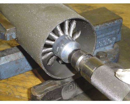 Perie de sârmă tubulară utilizată pentru debavurarea unei țevi metalice