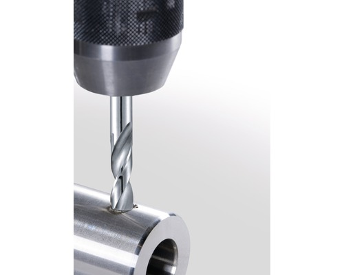 Burghiu metalic găurind o țeavă metalică