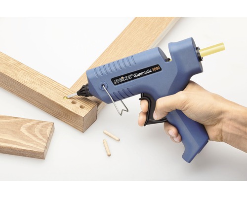 Pistol de lipit cu topire fierbinte Steinel Gluematic 5000 în uz cu bucăți de lemn și dibluri