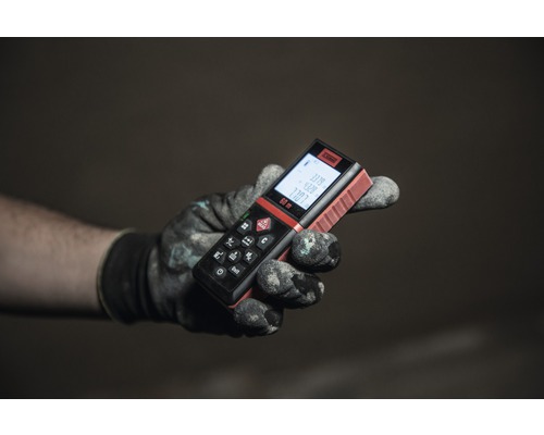 O mână cu o mănușă de lucru ține un telemetru