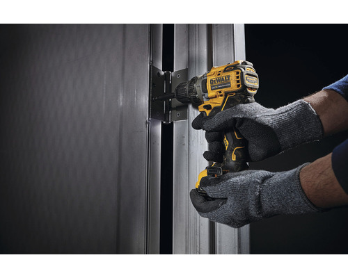 Mașină de găurit/înșurubat cu acumulator care fixează o balama de ușă