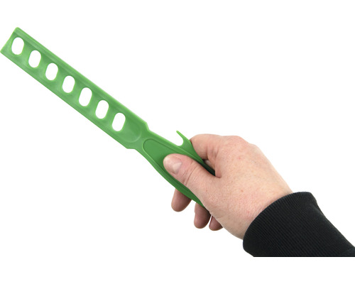 Mână care ține o lingură de amestecat cu găuri