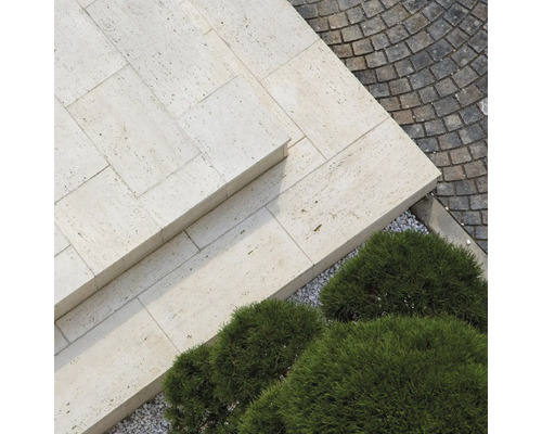 Exterior cu plăci de travertin, pavaj și arbuști verzi