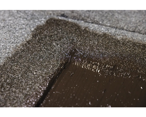 Prim-plan cu o reparație de acoperiș cu bitum.