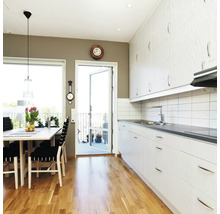 Bucătărie luminoasă cu zonă de luat masa, podea din lemn și acces la balcon.