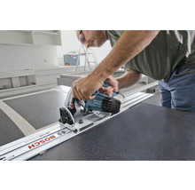 Meșter folosind un fierăstrău circular portabil cu șină de ghidare pentru a tăia un blat de lucru