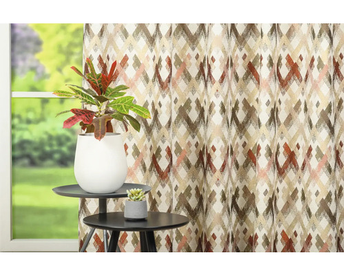 Cortină decorativă cu model grafic lângă două măsuțe laterale cu plante