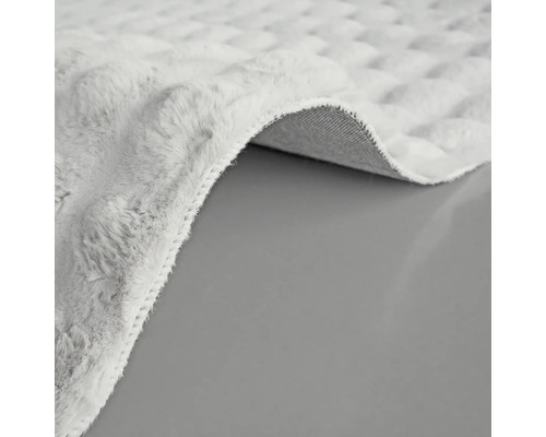 Imagine detaliată a unui covor deschis la culoare, cu model