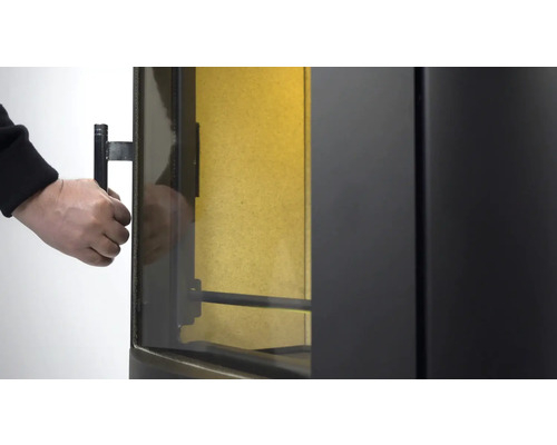 Prim-plan al unui șemineu pe lemne în timp ce se deschide ușa