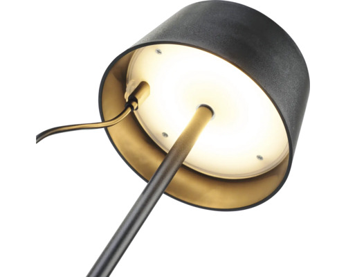 Prim-plan al unei lămpi de birou cu bază rotundă și abajur.