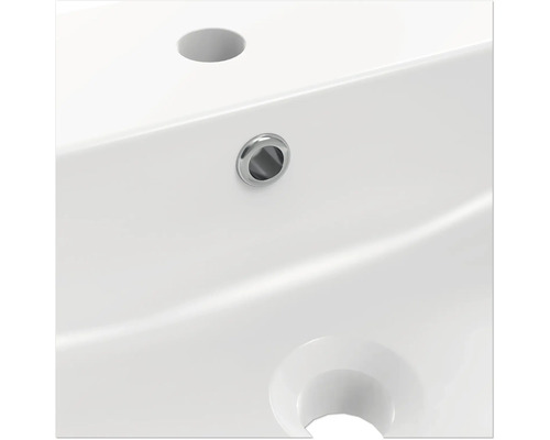 Prim-plan cu o chiuvetă albă, cu orificiu pentru robinet și preaplin