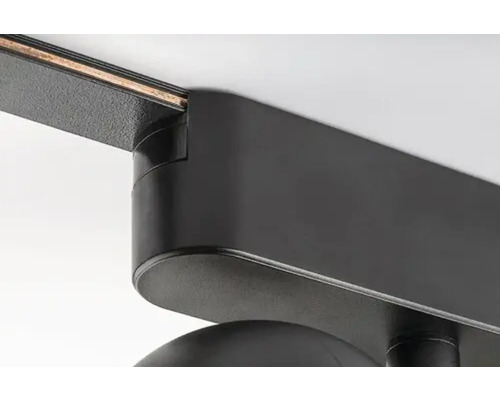 Prim-plan al unei șine de alimentare cu un spot luminos