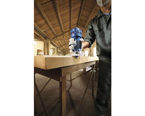 Persoană care frezează o bucată de lemn cu o freză verticală Bosch