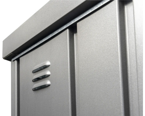 Prim-plan cu o căsuță de grădină metalică cu fante de ventilație